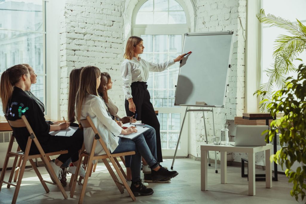 female-teacher-giving-presentation